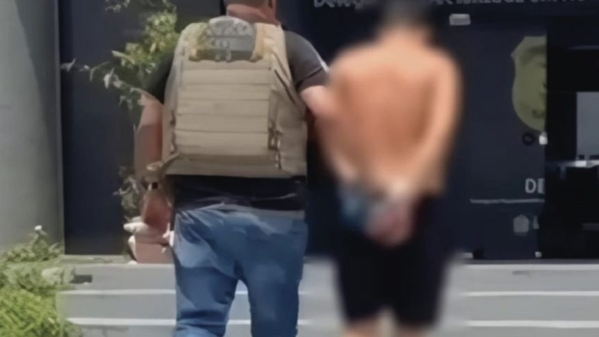 Policial prende homem em Manaus. O suspeito está com as mãos para trás.