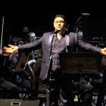 Tenor se apresenta em palco com orquestra, Encontro de Tenores no Teatro Amazonas.