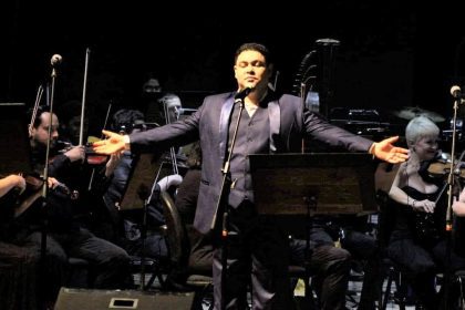 Tenor se apresenta em palco com orquestra, Encontro de Tenores no Teatro Amazonas.
