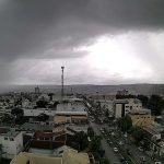 Vista aérea de cidade com céu nublado e prenúncio de chuva.