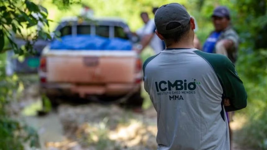 Agente ambiental do ICMBio com carro em área de mata.