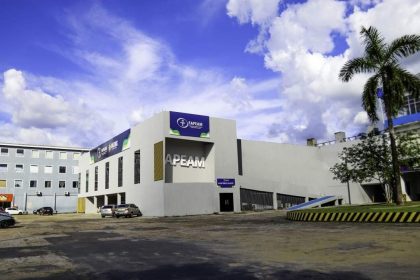 Fachada da FAPEAM, instituição de pesquisa do Amazonas, sob céu azul com nuvens.