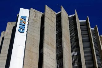 Fachada do edifício da Caixa Econômica Federal, com céu azul ao fundo.