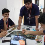Grupo de jovens jogando jogo de tabuleiro durante o torneio Jogatech em Tefé, Amazonas.