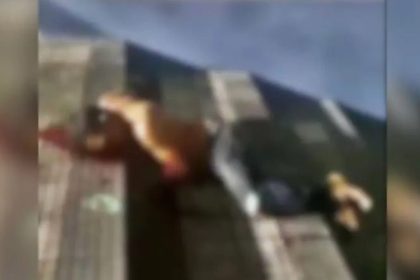 Homem ferido e ensanguentado no chão em Manaus.