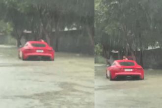 Chuva forte deixa carro de luxo parado em trecho alagado no bairro Tarumã