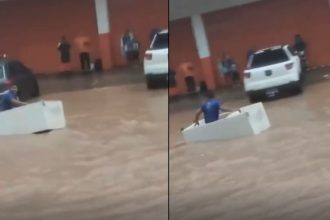 Homem usa geladeira como embarcação durante alagamento em Manaus