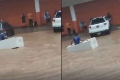 Homem usa geladeira como embarcação durante alagamento em Manaus