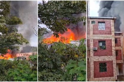 Incêndio em residências, com fumaça densa e chamas visíveis.